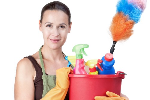 Professional cleaner tidying a kitchen in Greenwich