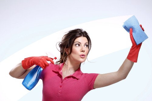 Commercial cleaners working in a Greenwich office with desks and meeting space
